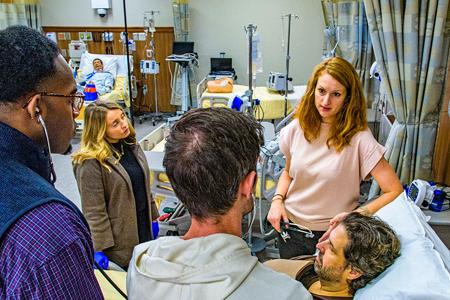 physician faculty and students using stethoscope