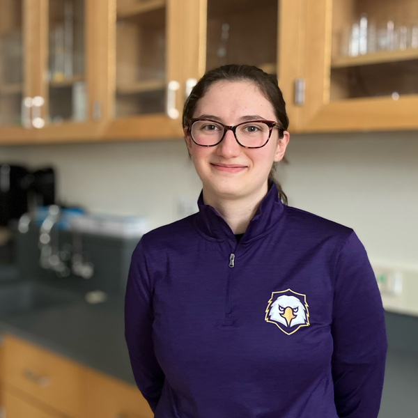 Olivia Dibble poses in a chemistry lab on campus