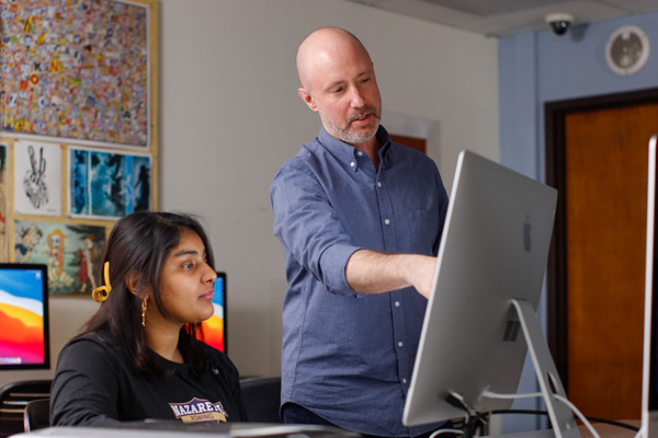 Stephen Wehner with student in graphic design classroom