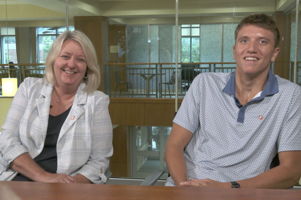 Kerry Brooks and Tyler Putney smile as they talk about their Lincoln Financial connections