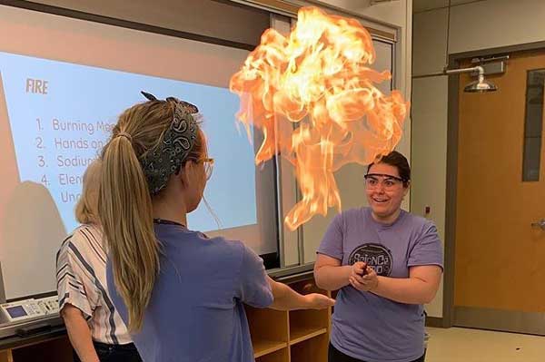 Meredith with a fireball in the air, demonstrating flammable gases