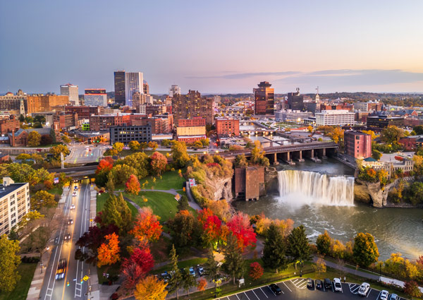 Overhead view of Rochester shows waterfall, skyline, colorful fall leaves on trees