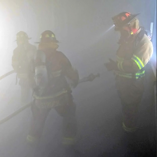 firefighters in a smoky building