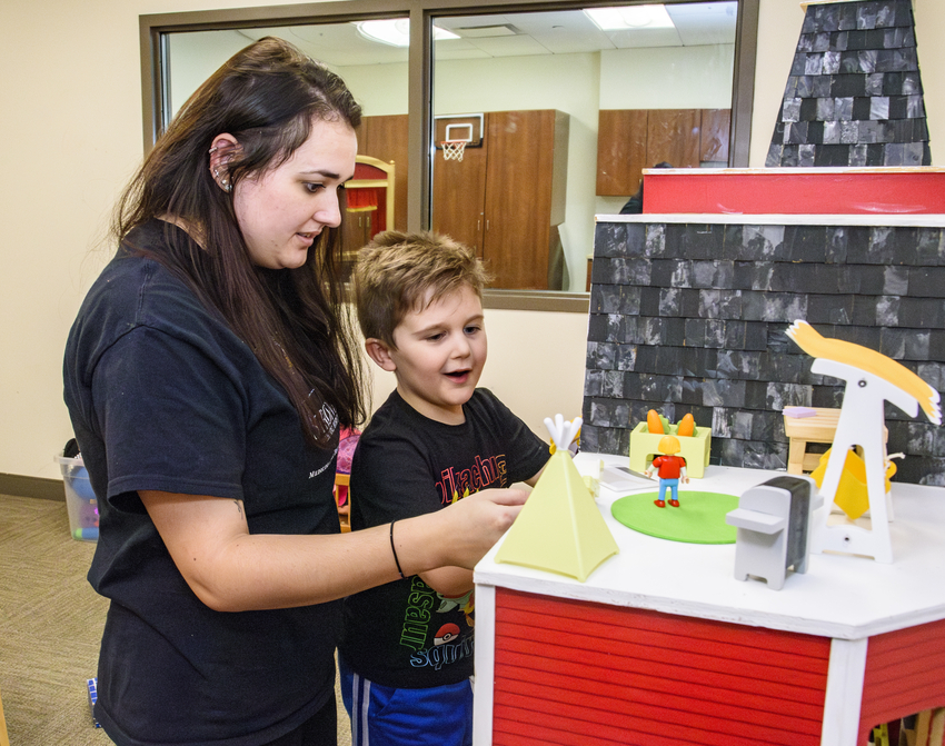 Woman and child playing with toys
