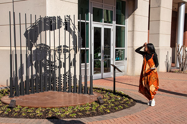 student observing sculpture of Rosa Parks