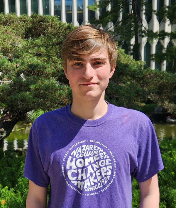 Jacob Koles in a Nazareth "home of the changemakers" T-shirt