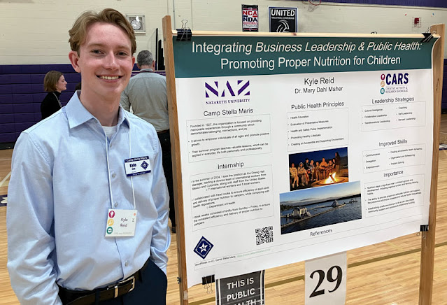 Kyle Reid with research poster about integrating business leadership & public health