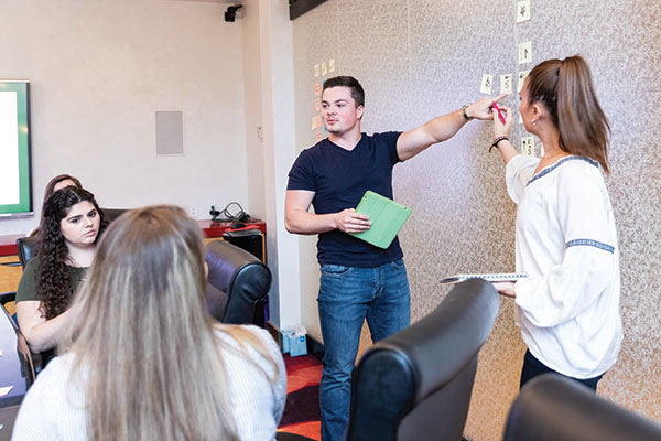 students presenting to group of peers