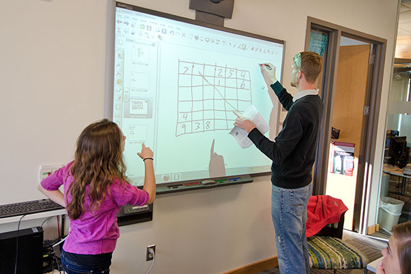 students constructing numbered grid on smartboard