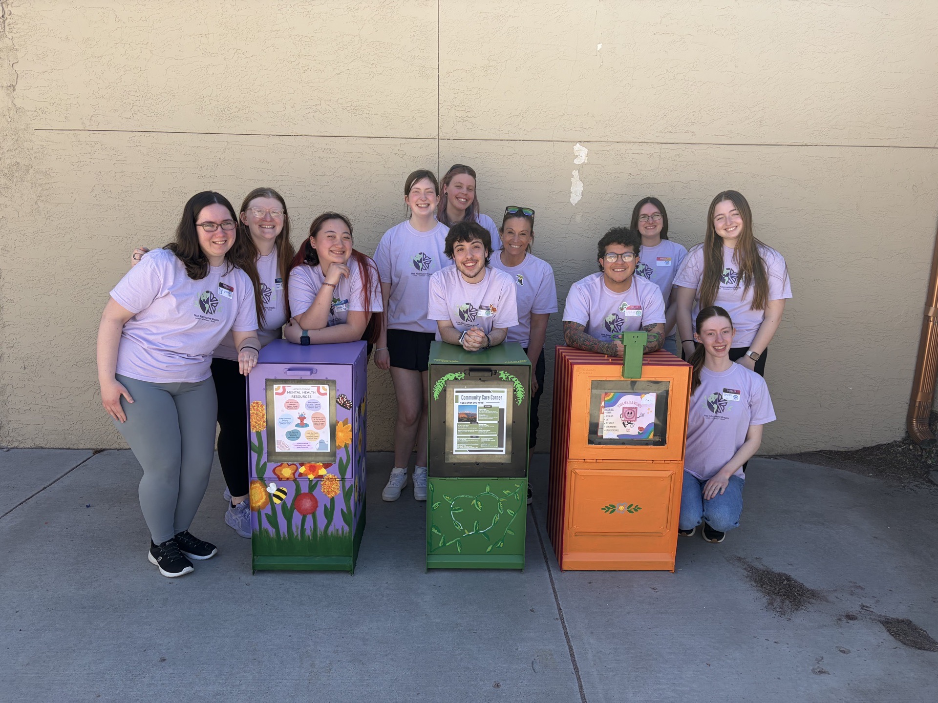 Students in front of painted supply boxes