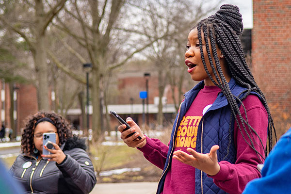 female student speaking at a women's rights event