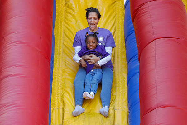 adult and child enjoying the inflatable slide at Naz Fest
