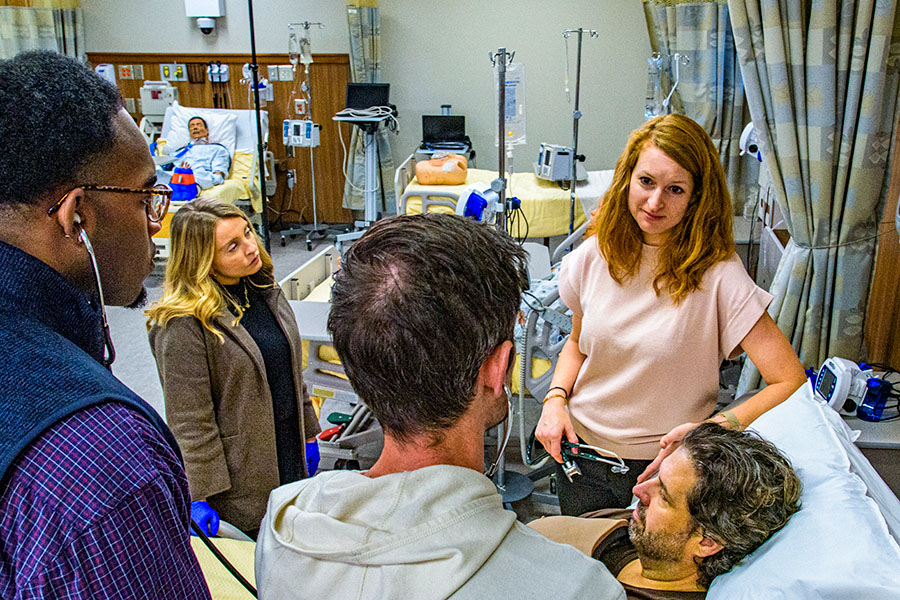 physician faculty and students using stethoscope