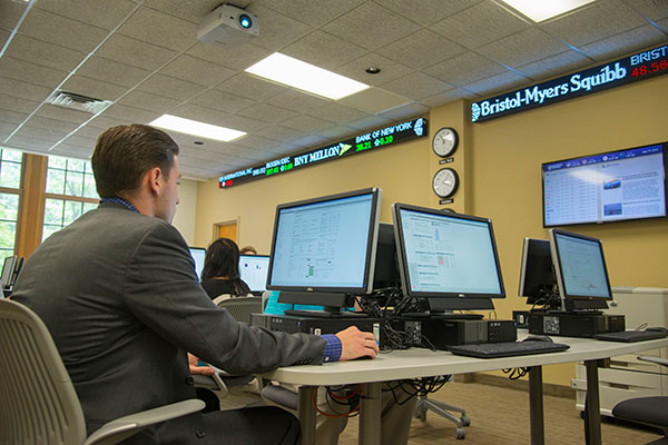 student using a computer in the finance lab