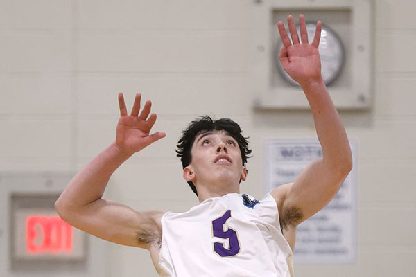 volleyball player jumping to strike ball