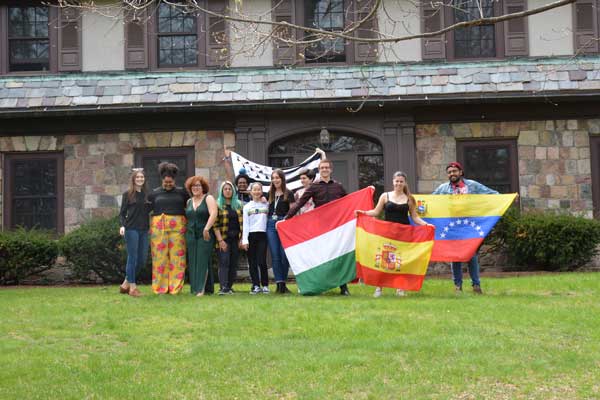 students holding up flags from foreign countries