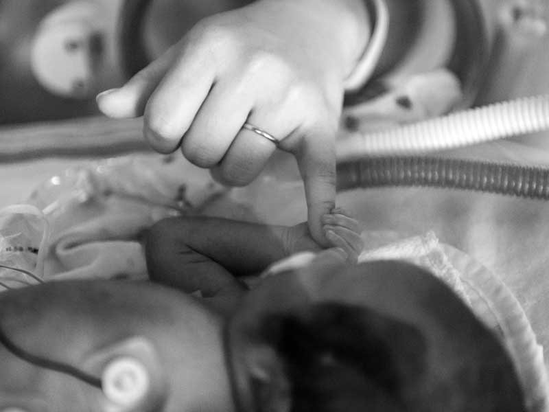 Tiny baby George holds Joanna Parker’s pinky