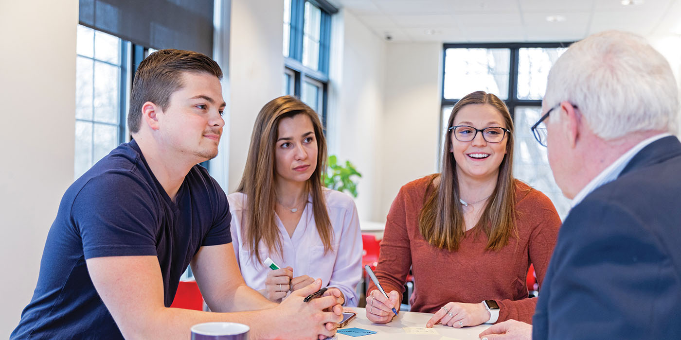 students in discussion with a professor