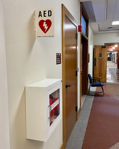 AED device on wall of first floor, with AED sign above it, Golisano Academic Center