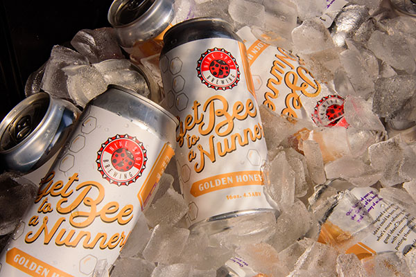 cans of Get Bee to a Nunnery beer on ice