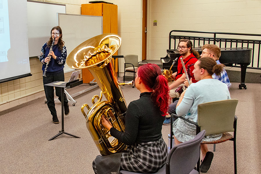 students holding instruments in classroom