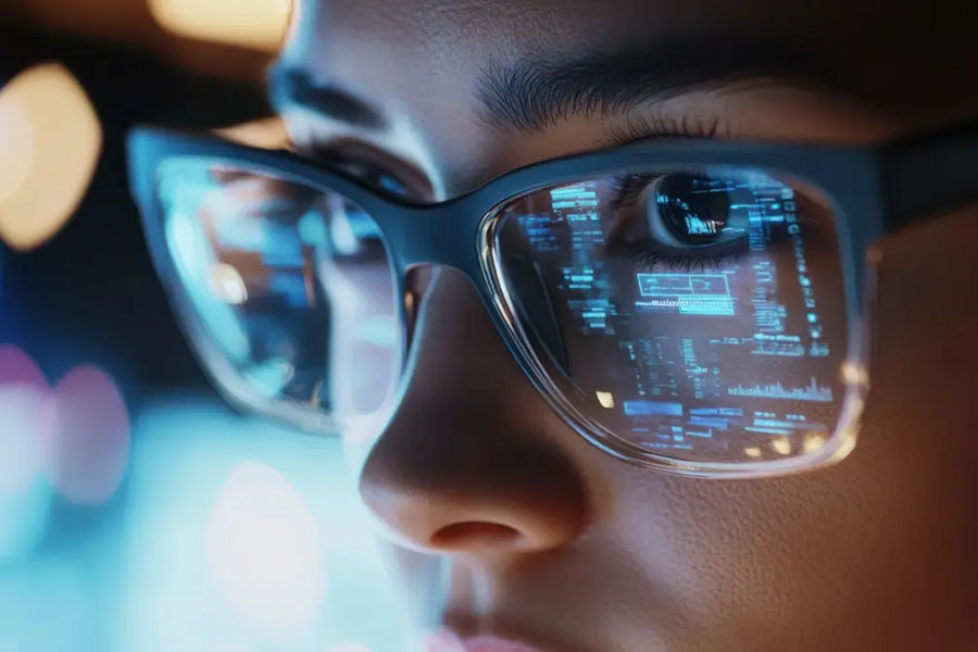 computer screen stats reflected in woman's glasses