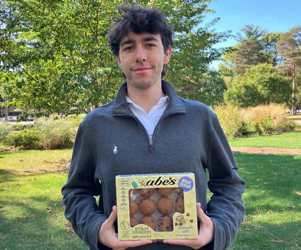 Joshua Powers holds a box of Abe's Muffins