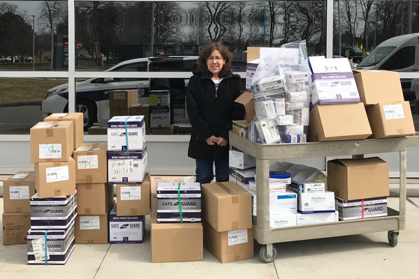 Jane Shebert outside Rochester General Hospital with boxes of supplies