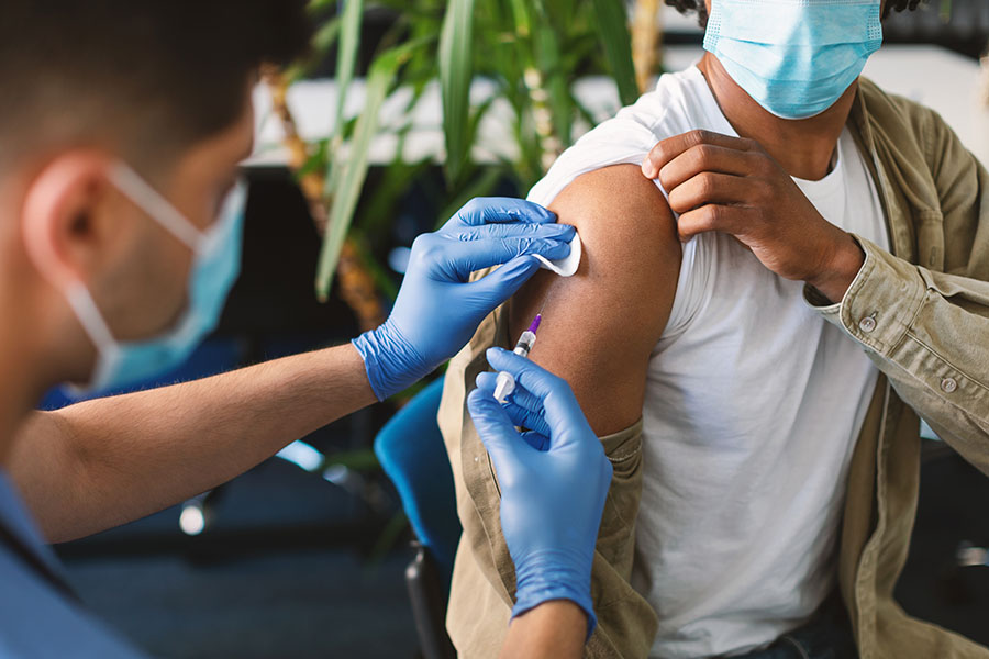 healthcare worker providing immunization shot